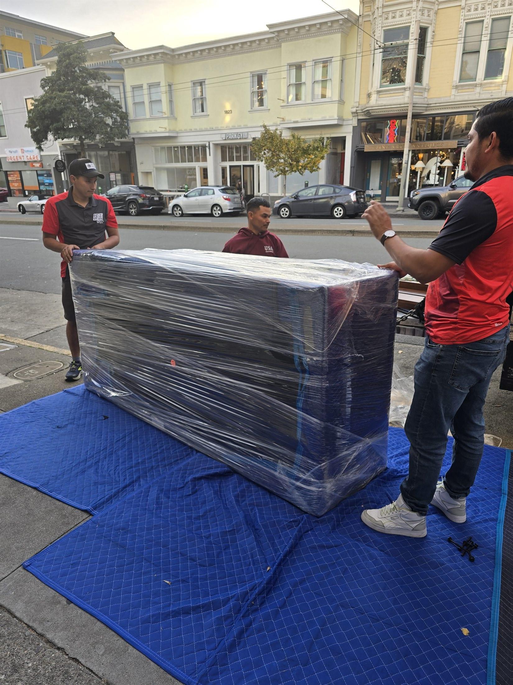 SF Bay Area Moving crew protecting furniture on a Bay Area street